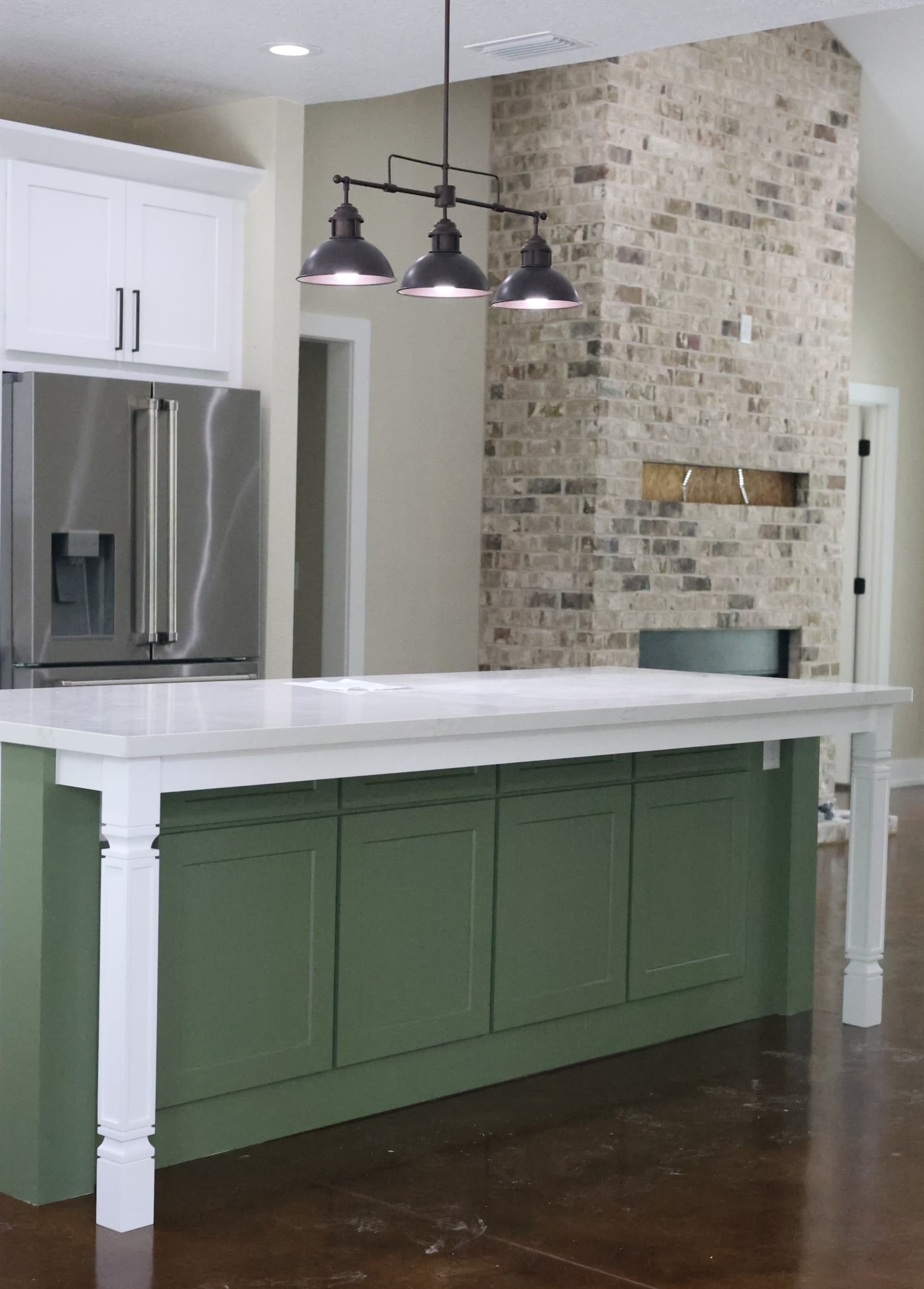 Gourmet kitchen overlooking stone fireplace in living room